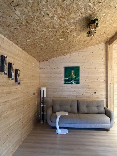 a living room with a couch and a table at COTTAGE cozy side in Mestia