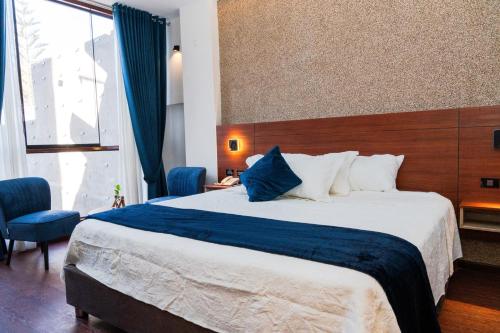 a hotel room with a large bed and a window at Hotel Terra by Refugio Ecológico in Arequipa