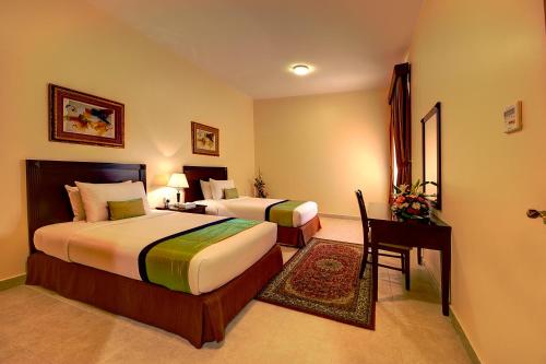 A bed or beds in a room at Asfar Resorts Al Ain