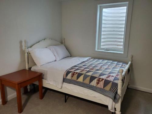 a small bedroom with a bed and a window at 4 bedroom 5 beds family house in Denver
