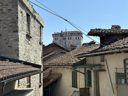 a view of an old building from between two buildings at Nel Caruggio - B&B in Mornese