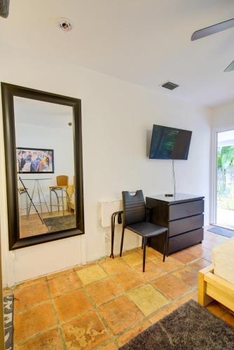 a living room with a desk and a mirror at Efficiency 2 on water Las Olas, beach and free kayaks in Fort Lauderdale