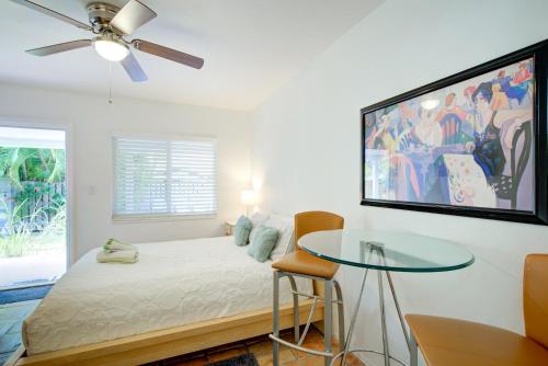 a bedroom with a bed and a glass table at Efficiency 2 on water Las Olas, beach and free kayaks in Fort Lauderdale