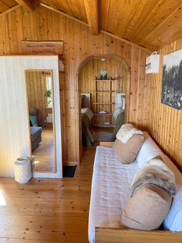 a room with a bed in a wooden house at Laplandliv cabin on the lake with hottub in Björkliden