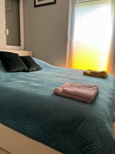 ein Bett mit zwei Handtüchern darauf in der Unterkunft Apartament u Buni in Breslau