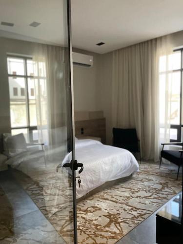 a bedroom with a bed and a sliding glass door at The N&N Executive in Al Madinah