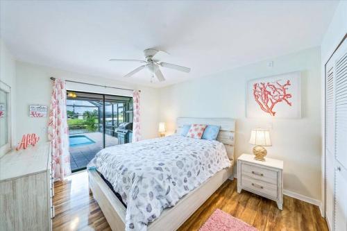 a white bedroom with a bed and a window at Honolulu East - Vacation home with heated pool and Gulf-access canal in Cape Coral