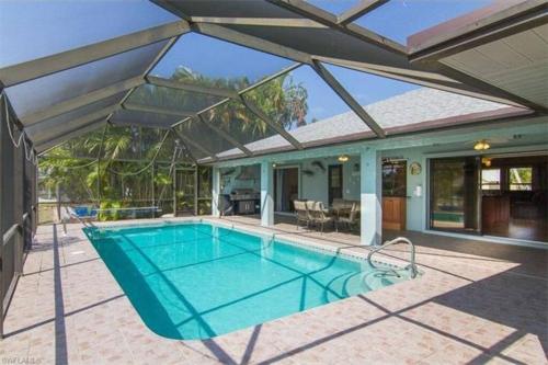 an image of a swimming pool in a house at Honolulu East - Vacation home with heated pool and Gulf-access canal in Cape Coral