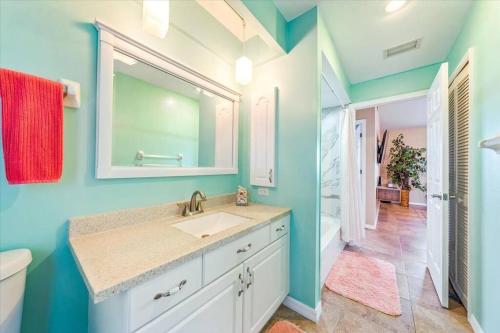 a bathroom with a sink and a mirror at Honolulu East - Vacation home with heated pool and Gulf-access canal in Cape Coral