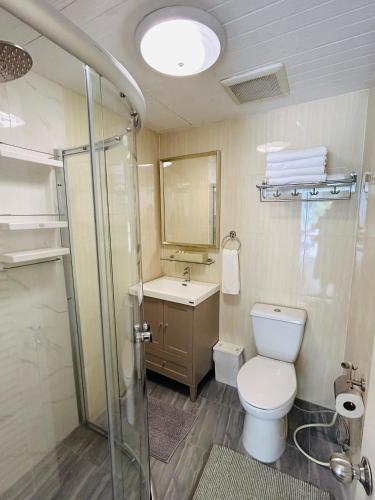 a bathroom with a toilet and a sink and a shower at Studio Room with private kitchen and Bathroom in Ban Phlu Yai