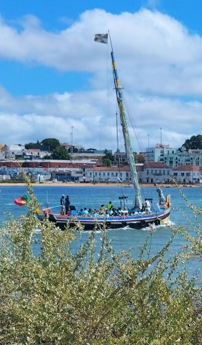 a sail boat in the water with people on it at Alojamento Local, Cantinho Verde in Corroios