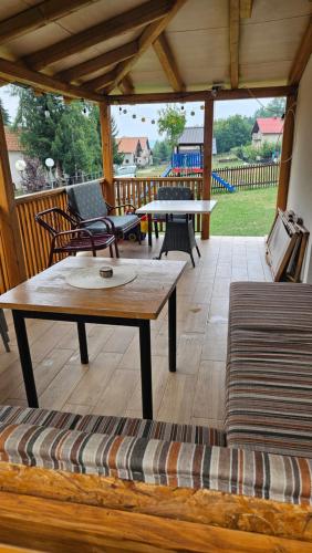 a screened in porch with a table and chairs at Ruža vetrova in Kušići