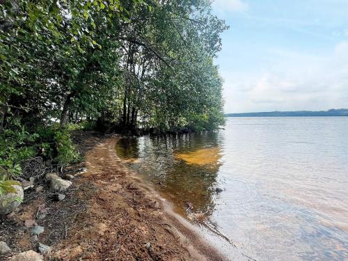 a shoreline with trees and a body of water at 4 person holiday home in BRAÅS-By Traum in Harshult