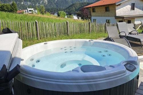 a large hot tub sitting in a backyard at Chalet Gamsknogel mit privatem Pool und Whirlpool in Inzell