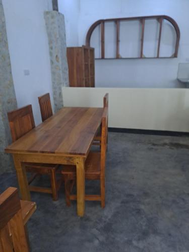a wooden table and chairs in a room at The Paradise In Kilimanjaro in Moshi