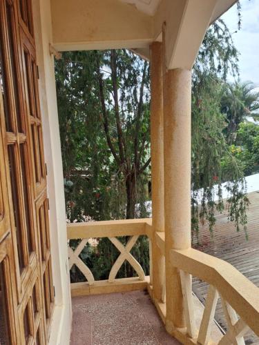 an open door to a balcony with a tree at The Paradise In Kilimanjaro in Moshi