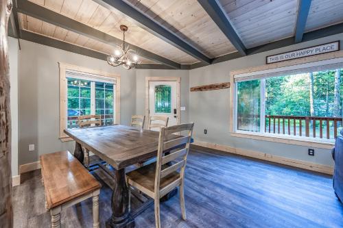 a dining room with a wooden table and chairs at The Sparrows Nest Cozy Charm Fire Pit Fun in Shaver Lake