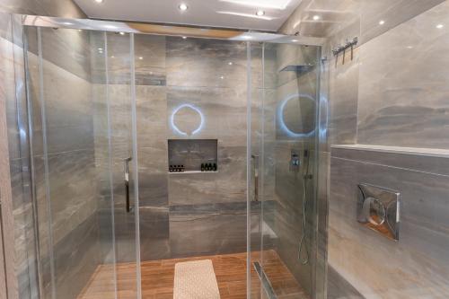 a shower with a glass door in a bathroom at BSP RENT ROOMs in Paralia Sikias