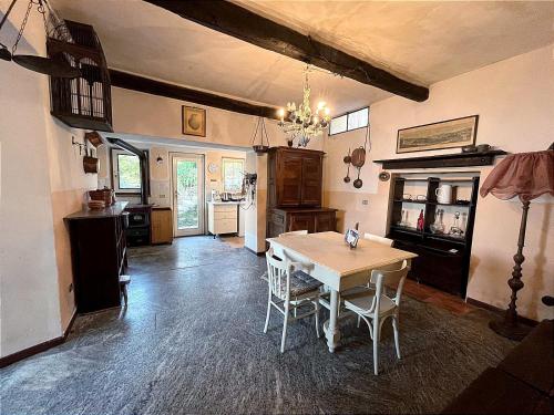 a kitchen with a table and chairs in a room at La Mulattiera - vista lago in Baveno