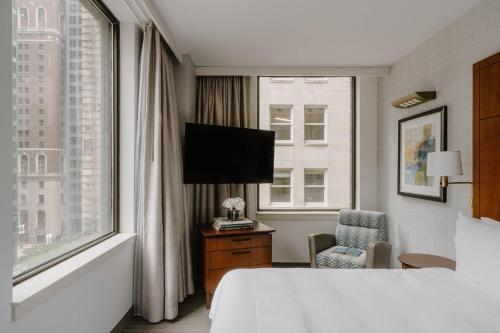 a hotel room with a bed and a window at Club Quarters Hotel Central Loop, Chicago in Chicago