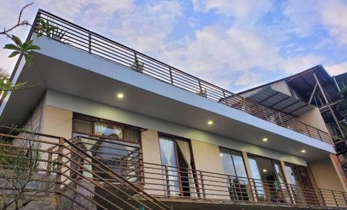 a house with balconies and stairs in front of it at Suite vista hermosa apartament in Macas