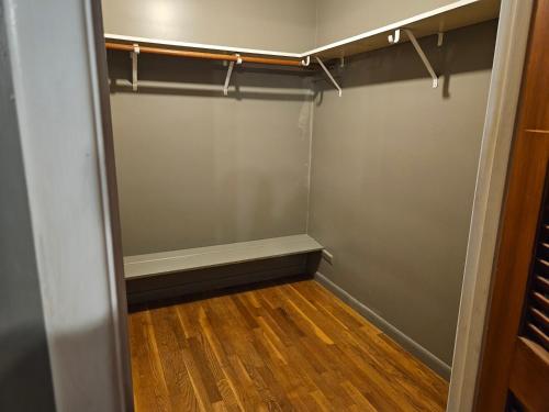 an empty walk in closet with a wood floor at Warwick Colonial Retreat in Warwick