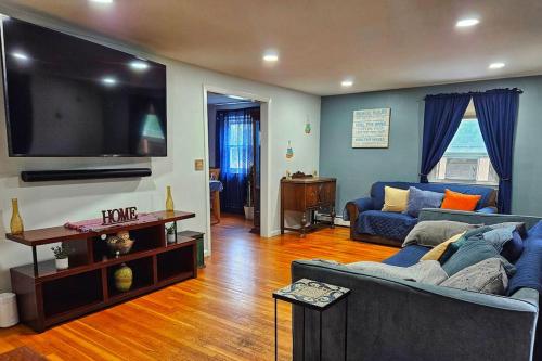 a living room with a couch and a flat screen tv at Warwick Colonial Retreat in Warwick