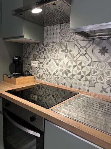 a kitchen with a counter top and a tile wall at Villa Gabri in Casa Berta