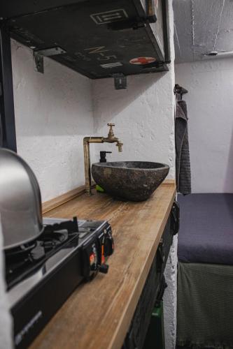 a kitchen with a counter with a sink and a stove at Vojenský bunker B in Bratislava