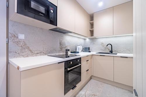 Kuchyň nebo kuchyňský kout v ubytování Apartament Przyjemny, Klimatyzacja, PW INVEST HOME