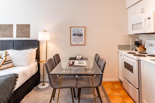 a small kitchen with a table and chairs in a room at Alpenglow Lodge by Elevate Vacations in Whistler