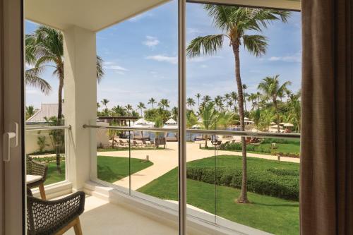 a view from the balcony of a resort with palm trees at Secrets La Romana All-Inclusive Adult Only Resort & Spa in Bayahibe
