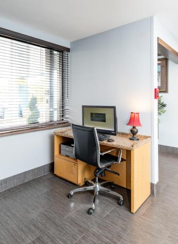 an office with a desk with a computer and a chair at Days Inn by Wyndham Fort Smith in Fort Smith