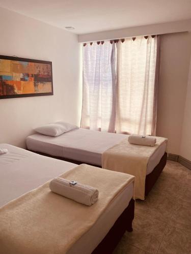 a bedroom with two beds and a window at Hotel Armenia Lions in Armenia