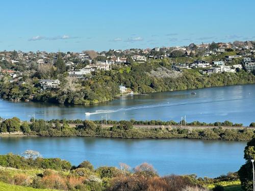 a view of a river with houses and a town at Basin View in Auckland