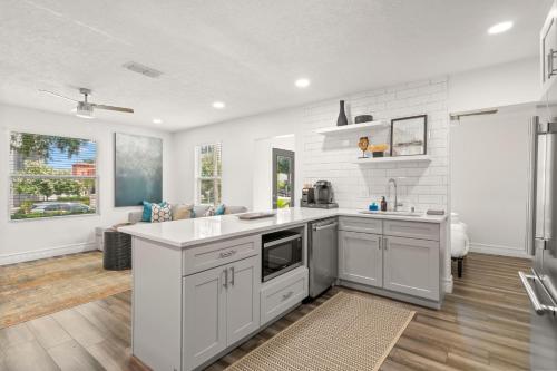 a kitchen with white cabinets and a counter top at NEW! SoHo Oasis - Incredible Home In Heart of SoHo District in Tampa