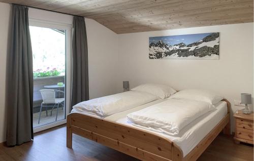 a large bed in a room with a window at Ferienwohnung St, Gallenkirch in Sankt Gallenkirch