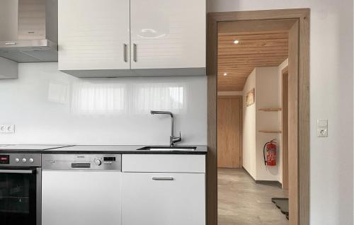 a kitchen with white cabinets and a sink at Ferienwohnung St, Gallenkirch in Sankt Gallenkirch