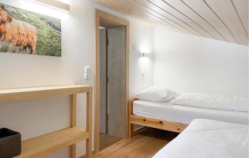 a bedroom with two beds and a painting on the wall at Ferienwohnung St, Gallenkirch in Sankt Gallenkirch