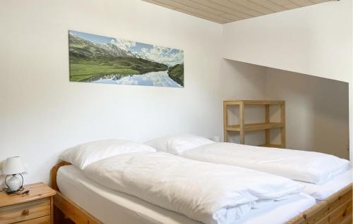 two beds in a room with white walls at Ferienwohnung St, Gallenkirch in Sankt Gallenkirch