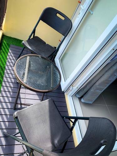 a table and a chair sitting next to a door at KH Rentals - near Mactan Airport in Lo-oc
