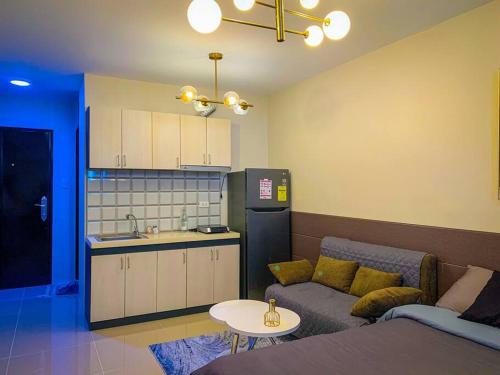 a living room with a couch and a kitchen at KH Rentals - near Mactan Airport in Lo-oc