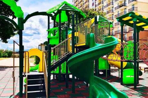 a playground with a slide in a park at KH Rentals - near Mactan Airport in Lo-oc