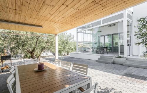 an outdoor patio with a wooden table and chairs at Stunning Home In Catenanuova in Centuripe