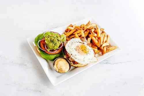 a plate of food with a sandwich and french fries at Accent Inns Burnaby in Burnaby