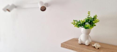 a vase with flowers in it sitting on a table at Apartment MAYA in Nečujam