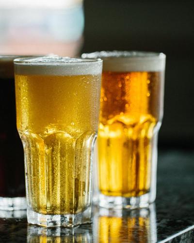two glasses of beer sitting on a table at Accent Inns Burnaby in Burnaby