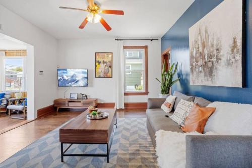 a living room with a couch and a ceiling fan at 5 bedrooms AC Designer Island Paradise Getaway in Atlantic City