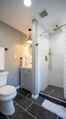 a bathroom with a toilet and a shower at 5 bedrooms AC Designer Island Paradise Getaway in Atlantic City