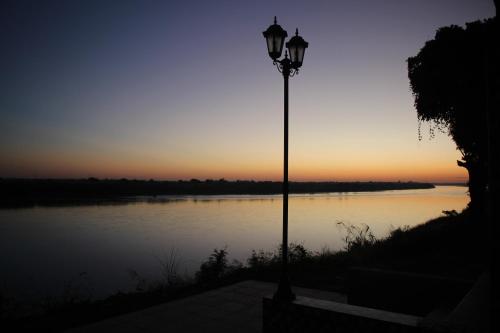 a street light next to a body of water at Mekong Tarawadee Villa in Tha Bo